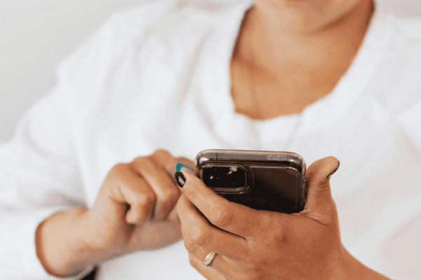 Person-using-smartphone-to-manage-calls-with-AI-phone-assistant-technology