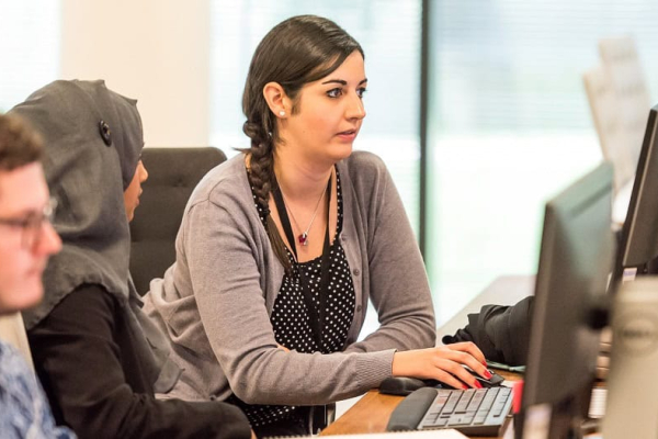A male and female office worker reviewing a customer service strategy.